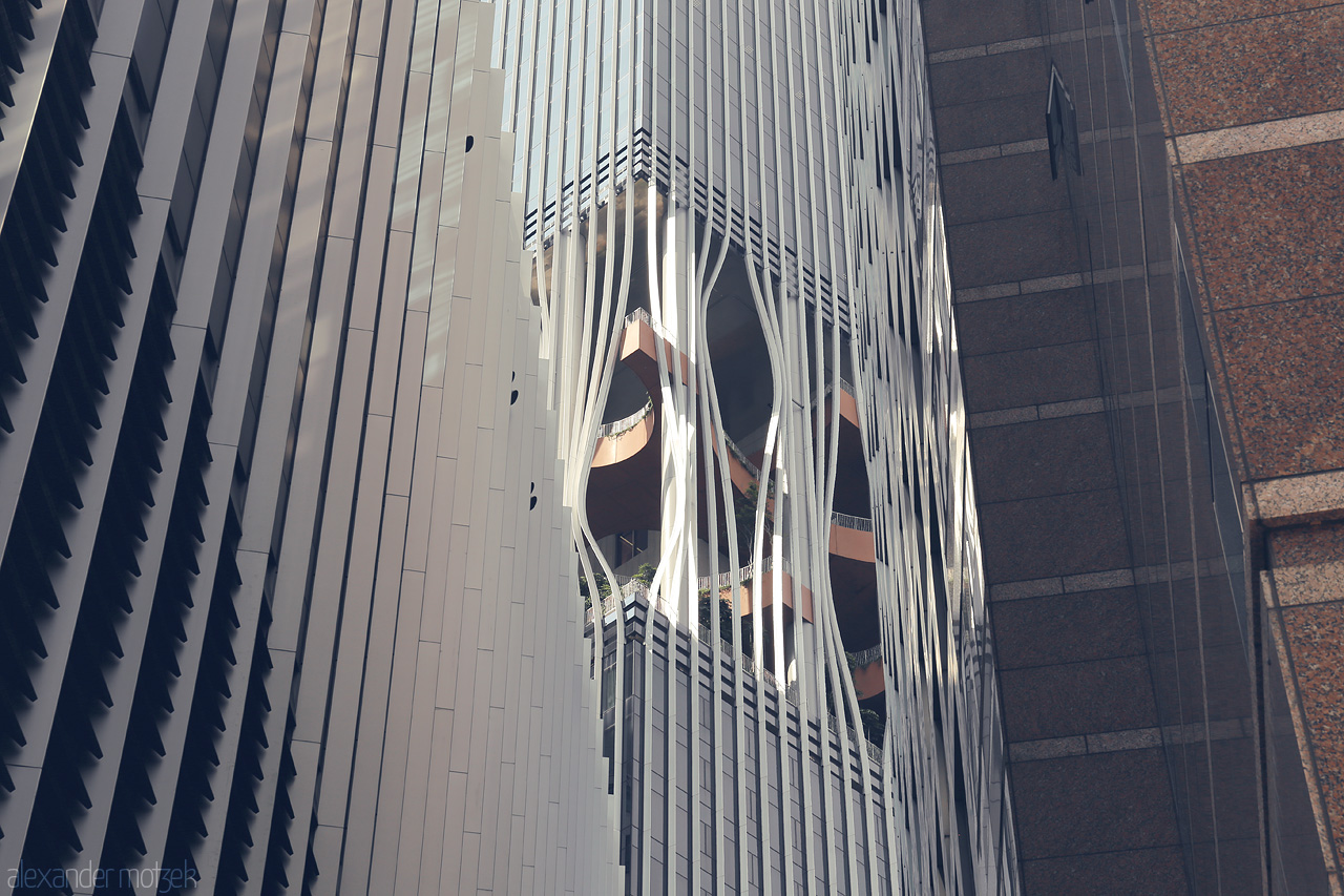 Steel Alchemy in the Lion City Foto von A striking reflection of modern architecture in Singapore's urban landscape, showcasing sleek metallic designs and dynamic forms.