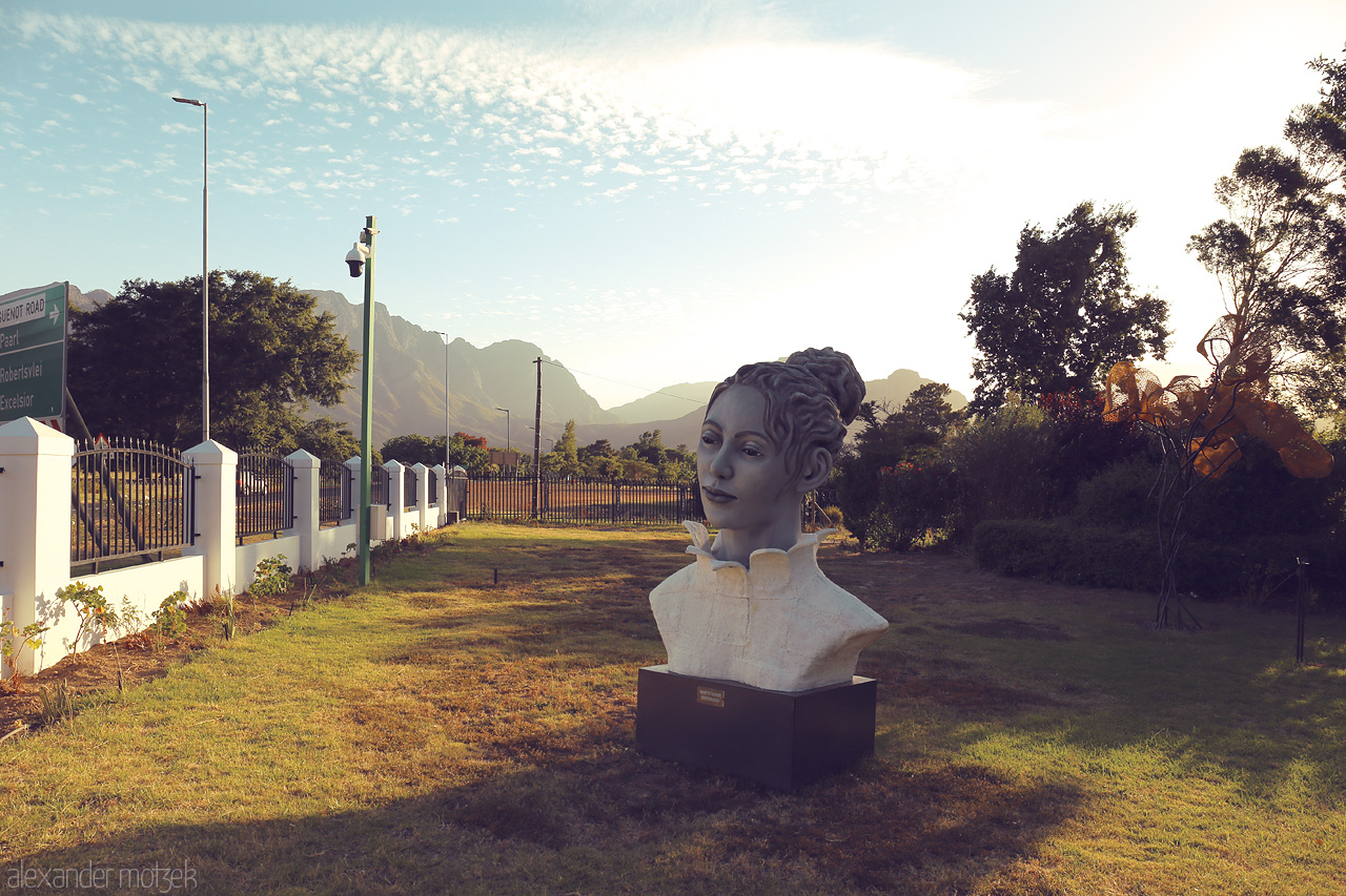 Foto von A captivating sculpture graces the lush landscapes of Franschhoek, South Africa, under a sky painted with whispers of clouds.