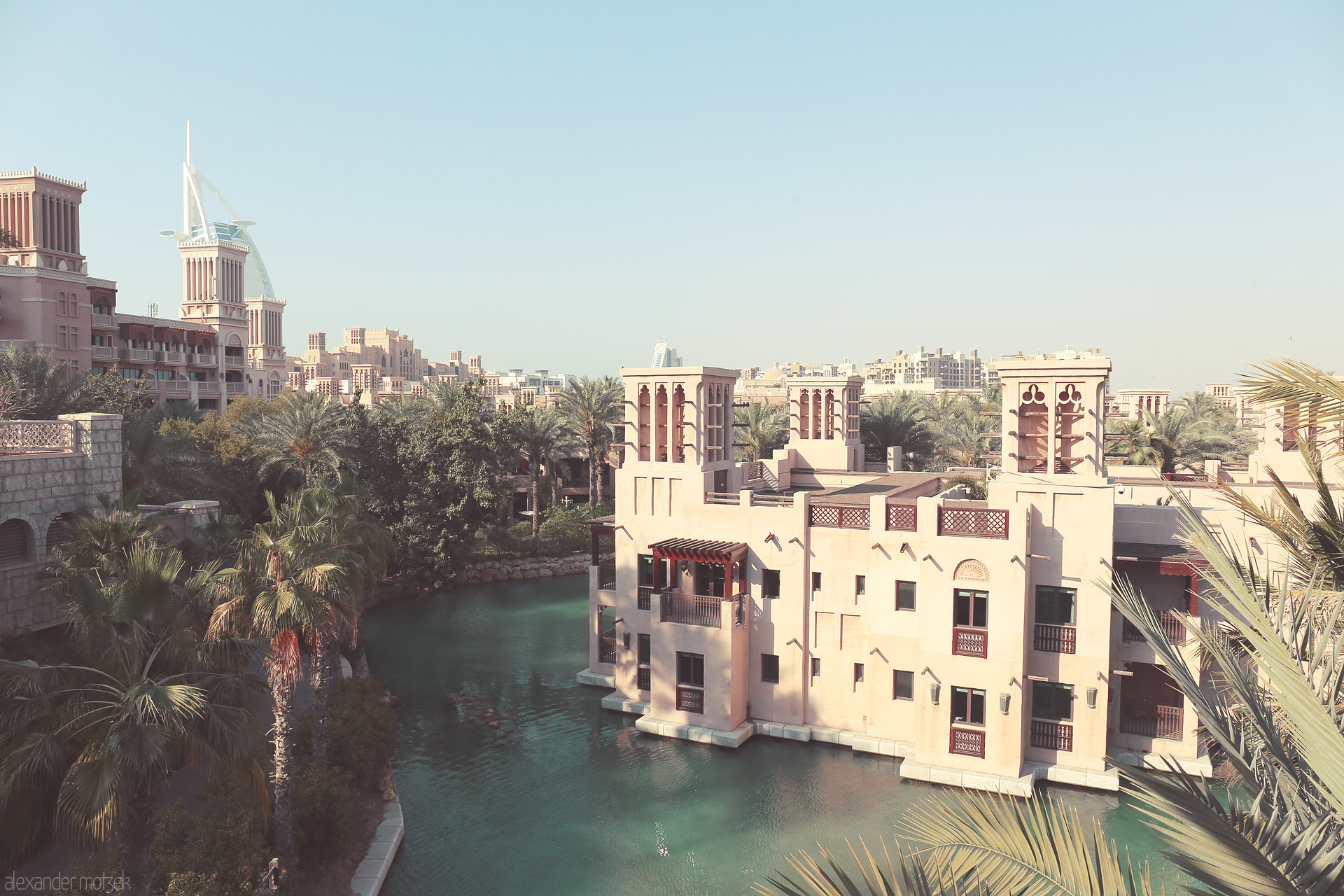Foto von Traditional wind towers and turquoise canals frame Dubai's Madinat Jumeirah, with the Burj Al Arab gleaming in the background.